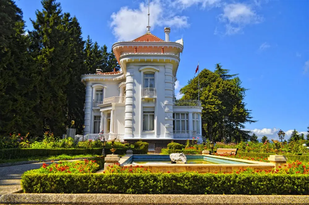 Clean white home exterior with formal gardens